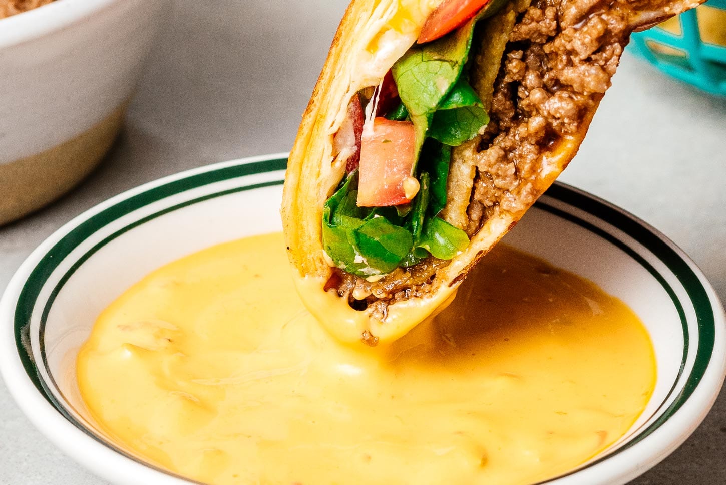 crunchwrap dipped in queso | foodiesanddrink.com