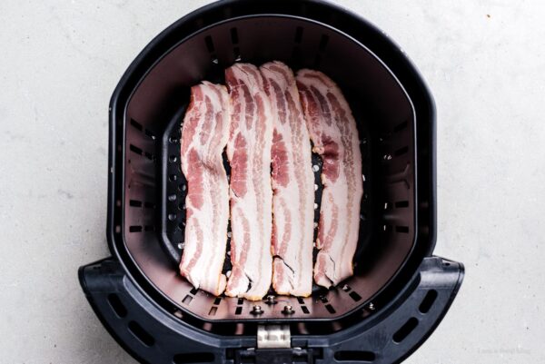 bacon in an air fryer basket | foodiesanddrink.com