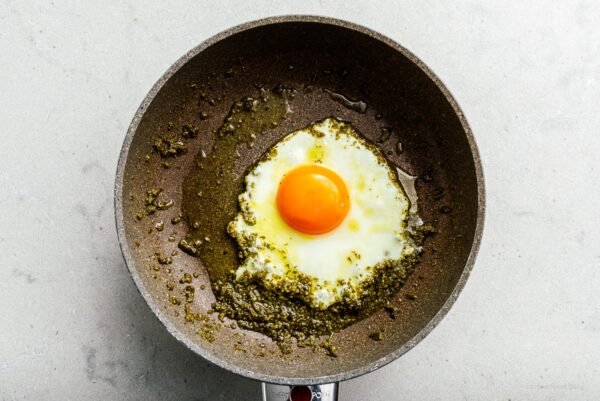 frying egg in pesto | foodiesanddrink.com