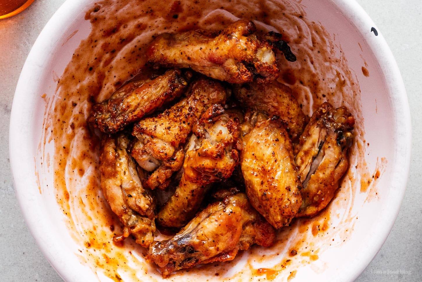 air fryer chicken wings tossed in hot sauce | foodiesanddrink.com