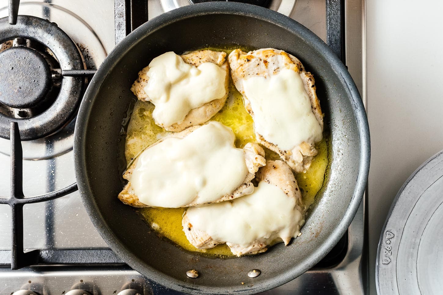 melting cheese on chicken | foodiesanddrink.com